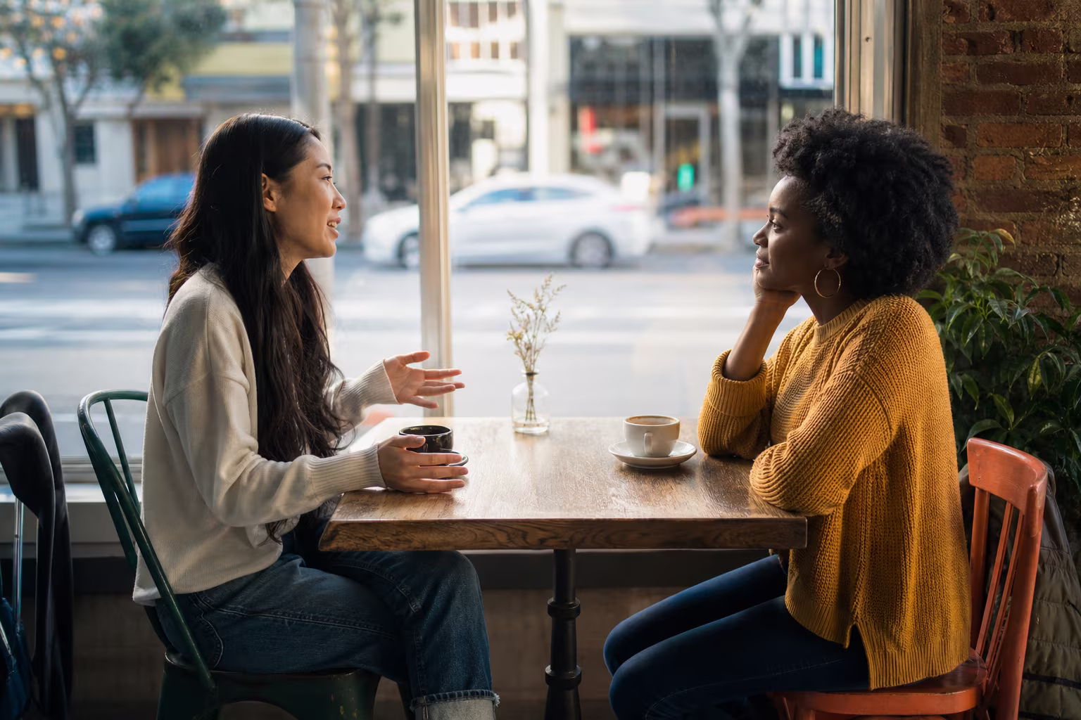 Two people meeting for the first time over coffee in a neighborhood cafe